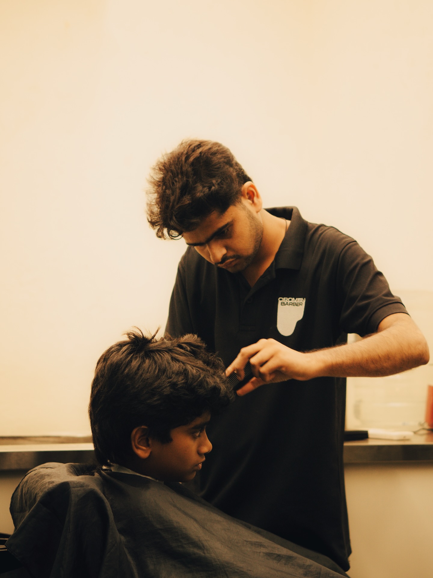 A Cromen barber in the house polo, mid-cut